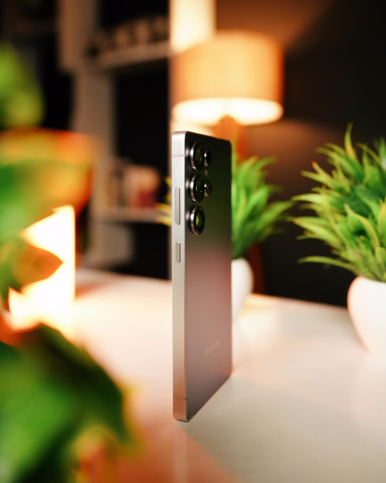 Modern smartphone on table with warm lighting, perfect for tech enthusiasts.